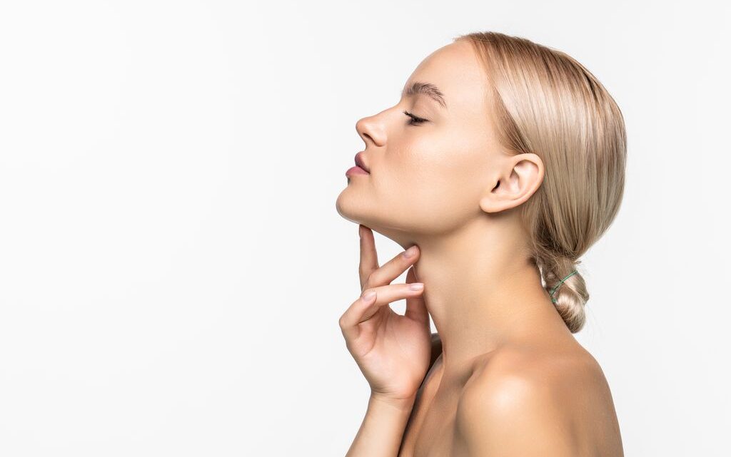 Beautiful young girl touching her face. Youth and skin care concept. Skin care